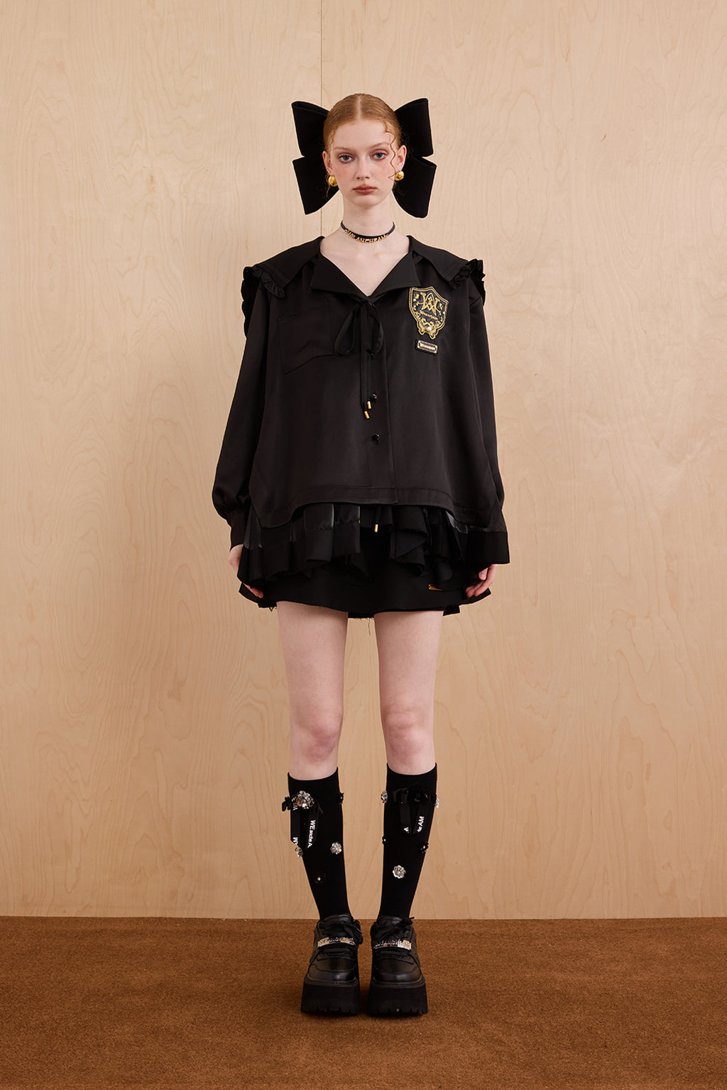 Model wearing sweet V-neck navy collar shirt dress with layered ruffle hem