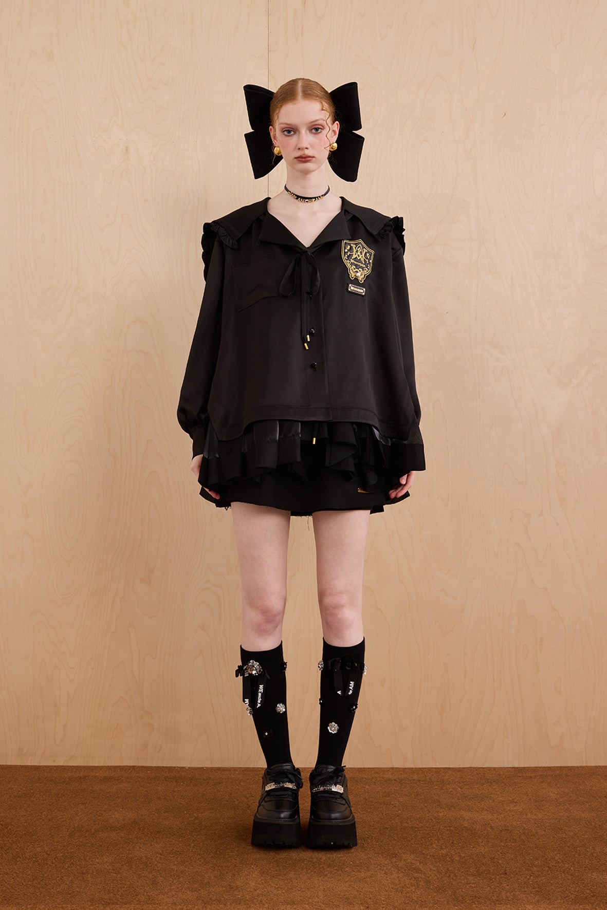 Model wearing sweet V-neck navy collar shirt dress with layered ruffle hem