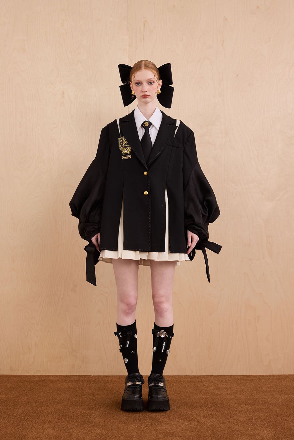 Model wearing Tiger Sovereign pleated suit with check fabric and bow ties