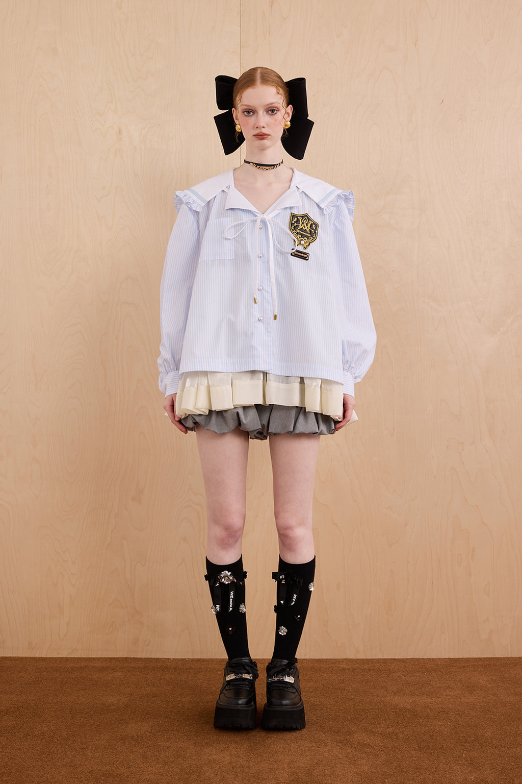 Model wearing sweet V-neck navy collar shirt dress with layered ruffle hem