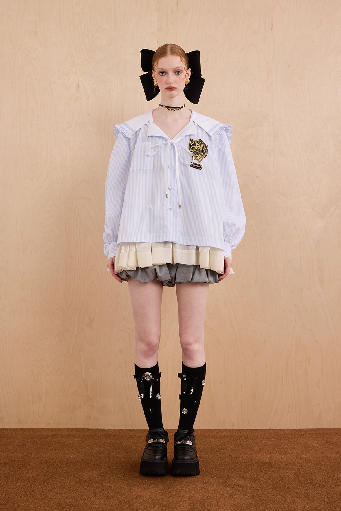 Model wearing sweet V-neck navy collar shirt dress with layered ruffle hem