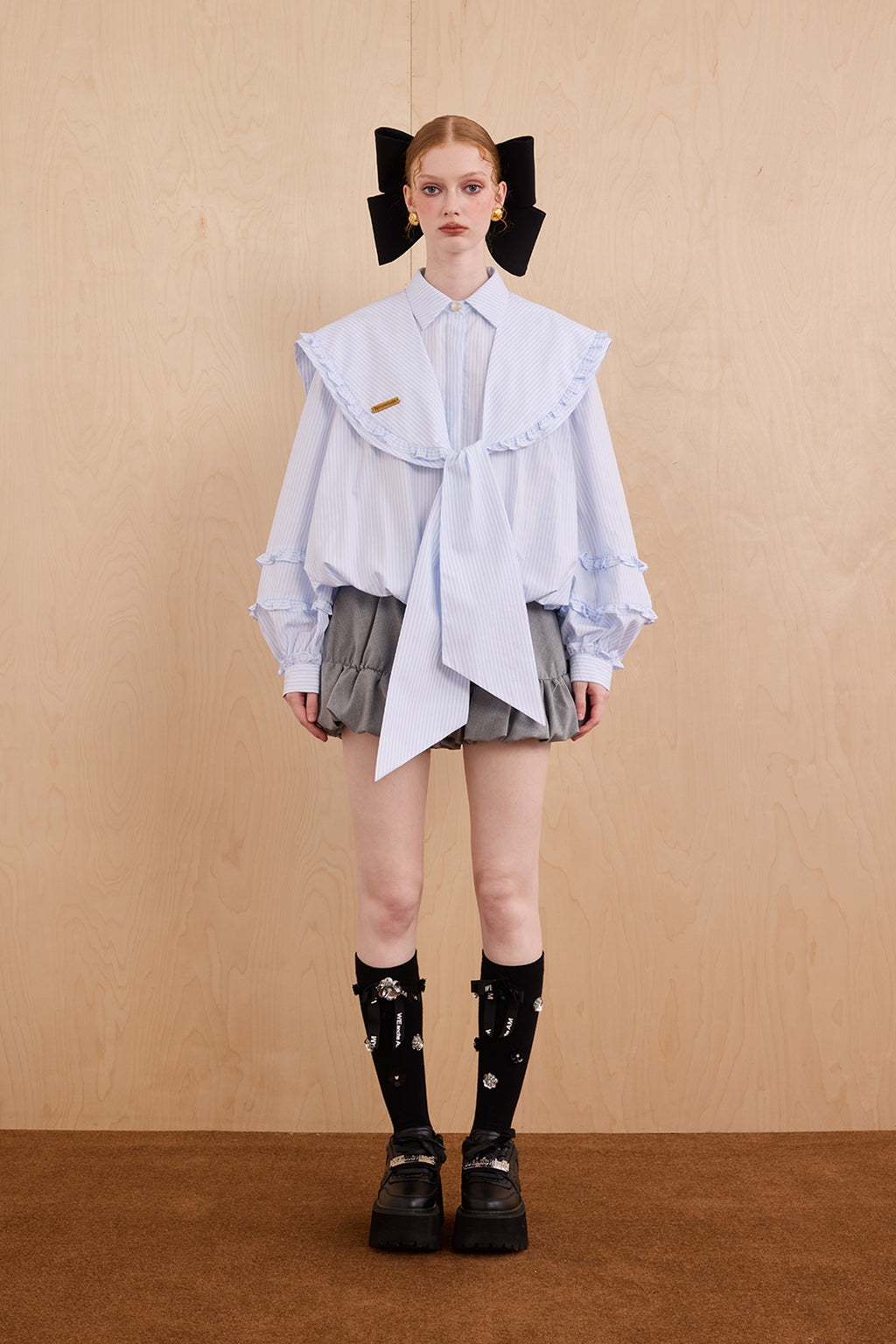Model wearing college-style shirt with detachable navy collar and bubble hem