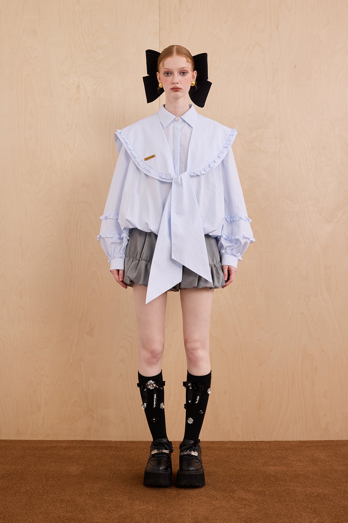 Model wearing college-style shirt with detachable navy collar and bubble hem