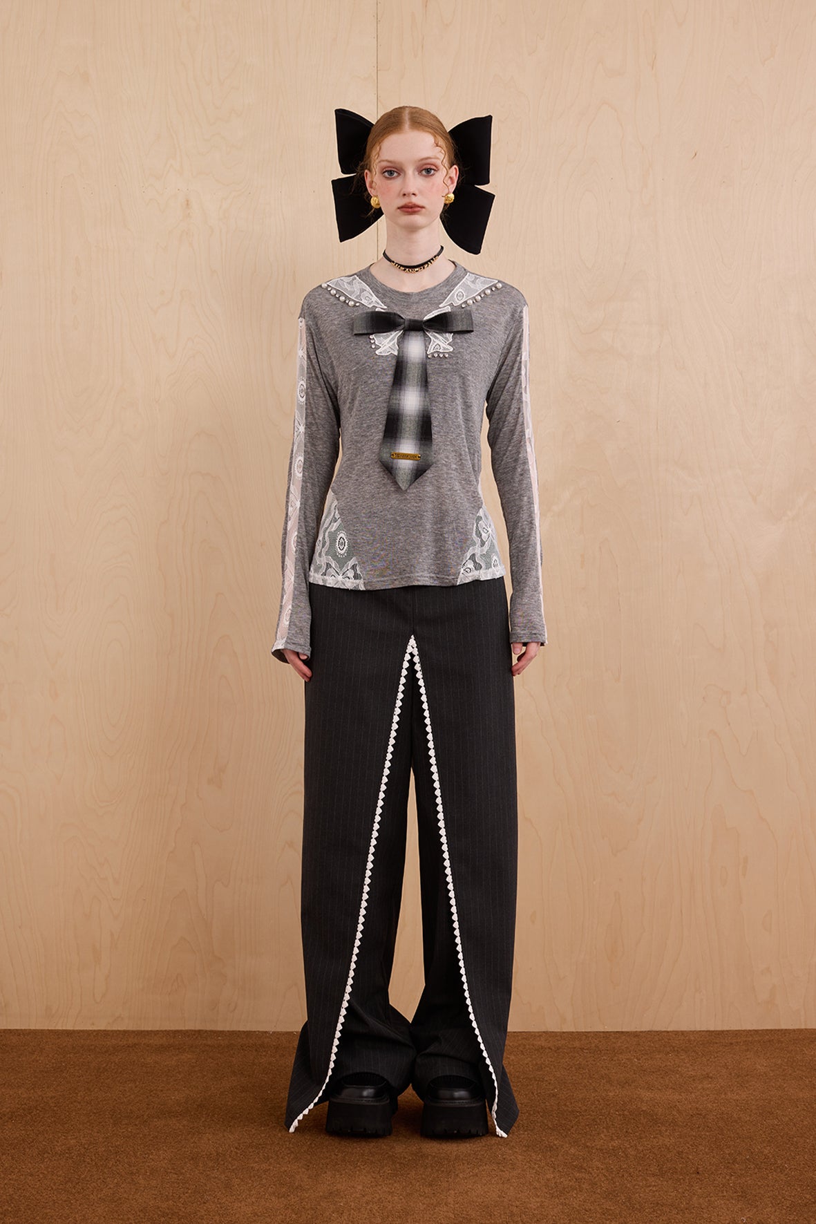 Model wearing slim-fit tie-neck wool blend top with lace accents – WEANCHEAM