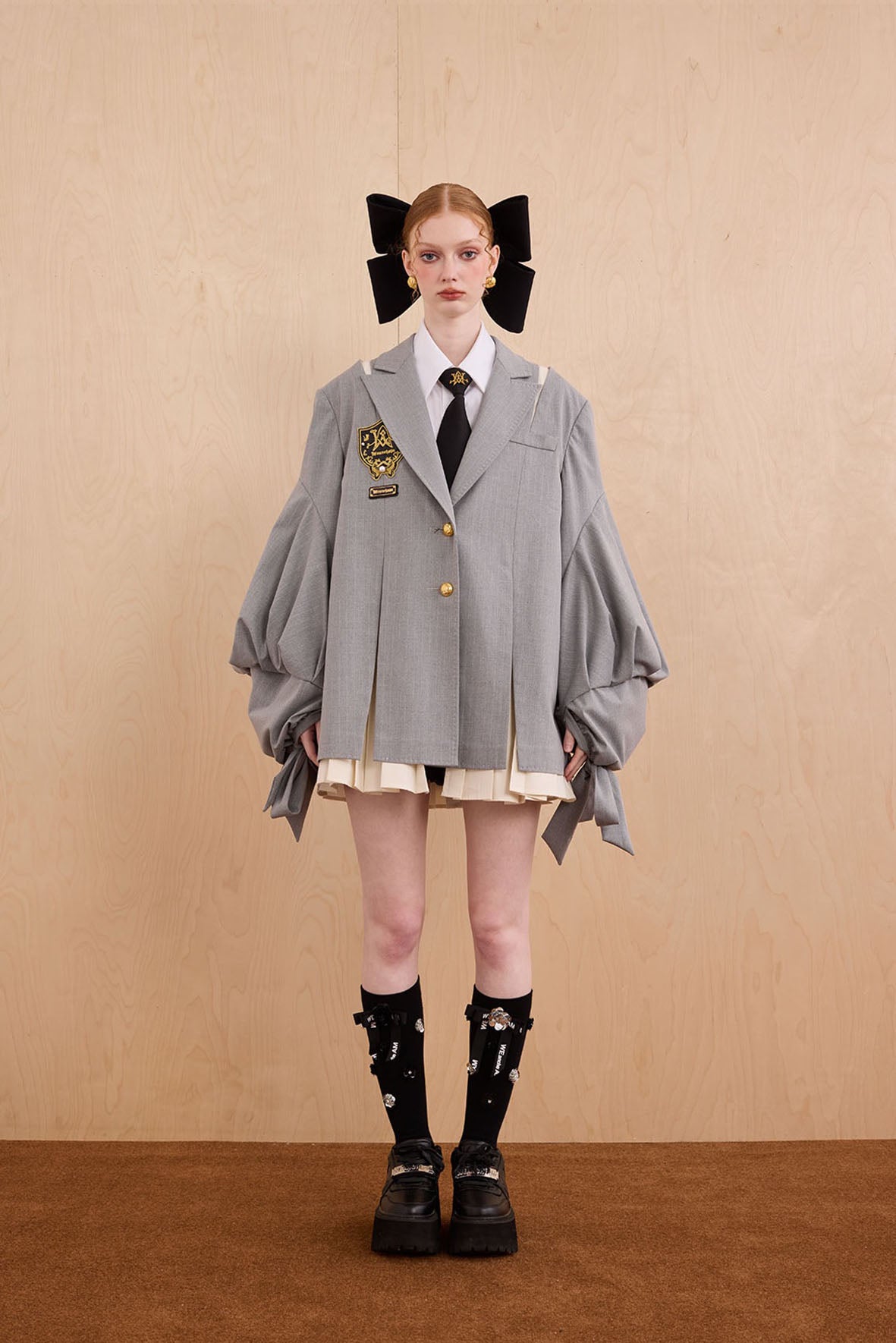Model wearing Tiger Sovereign pleated suit with check fabric and bow ties