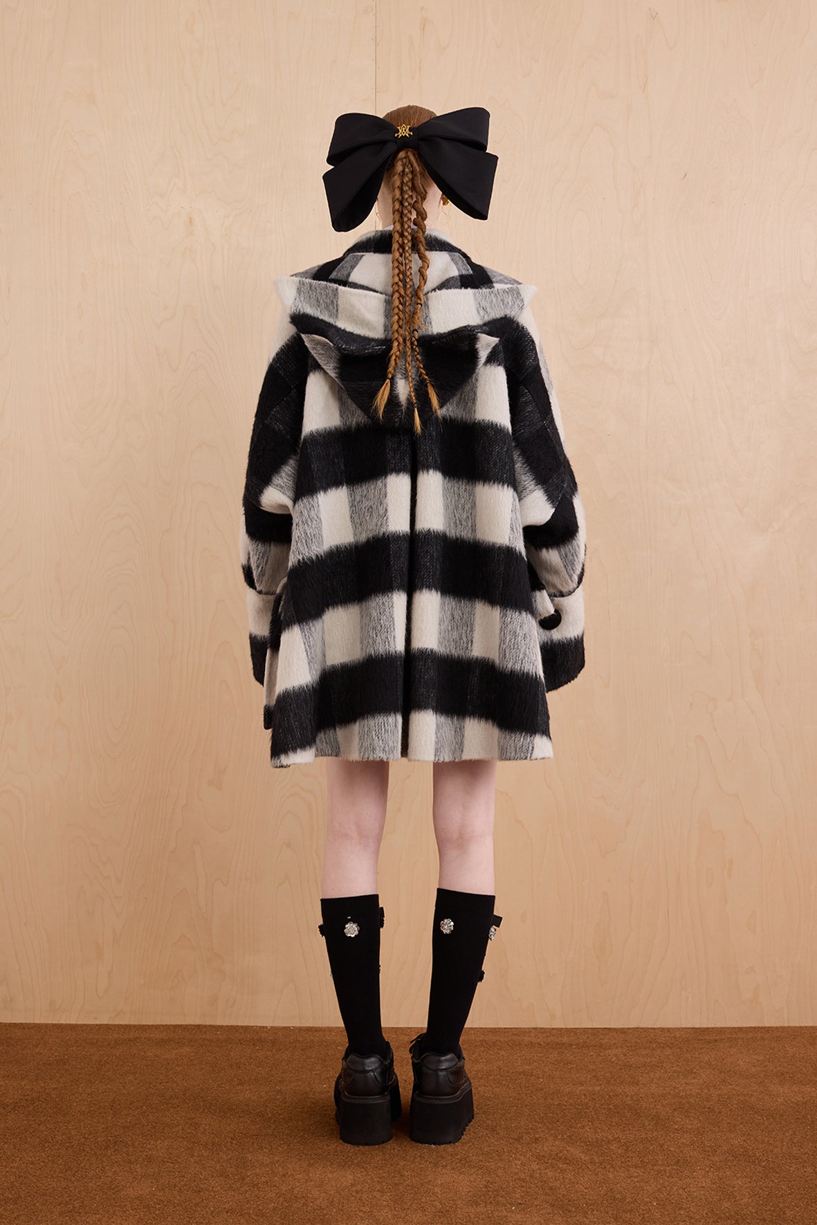 Model wearing merino wool reversible hoodie jacket with cat ears and bows