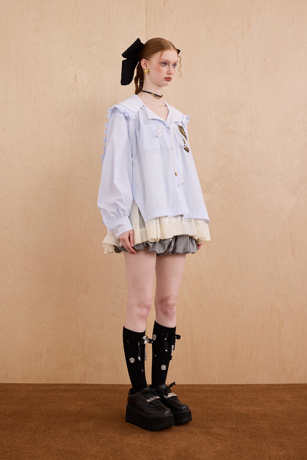 Model wearing sweet V-neck navy collar shirt dress with layered ruffle hem