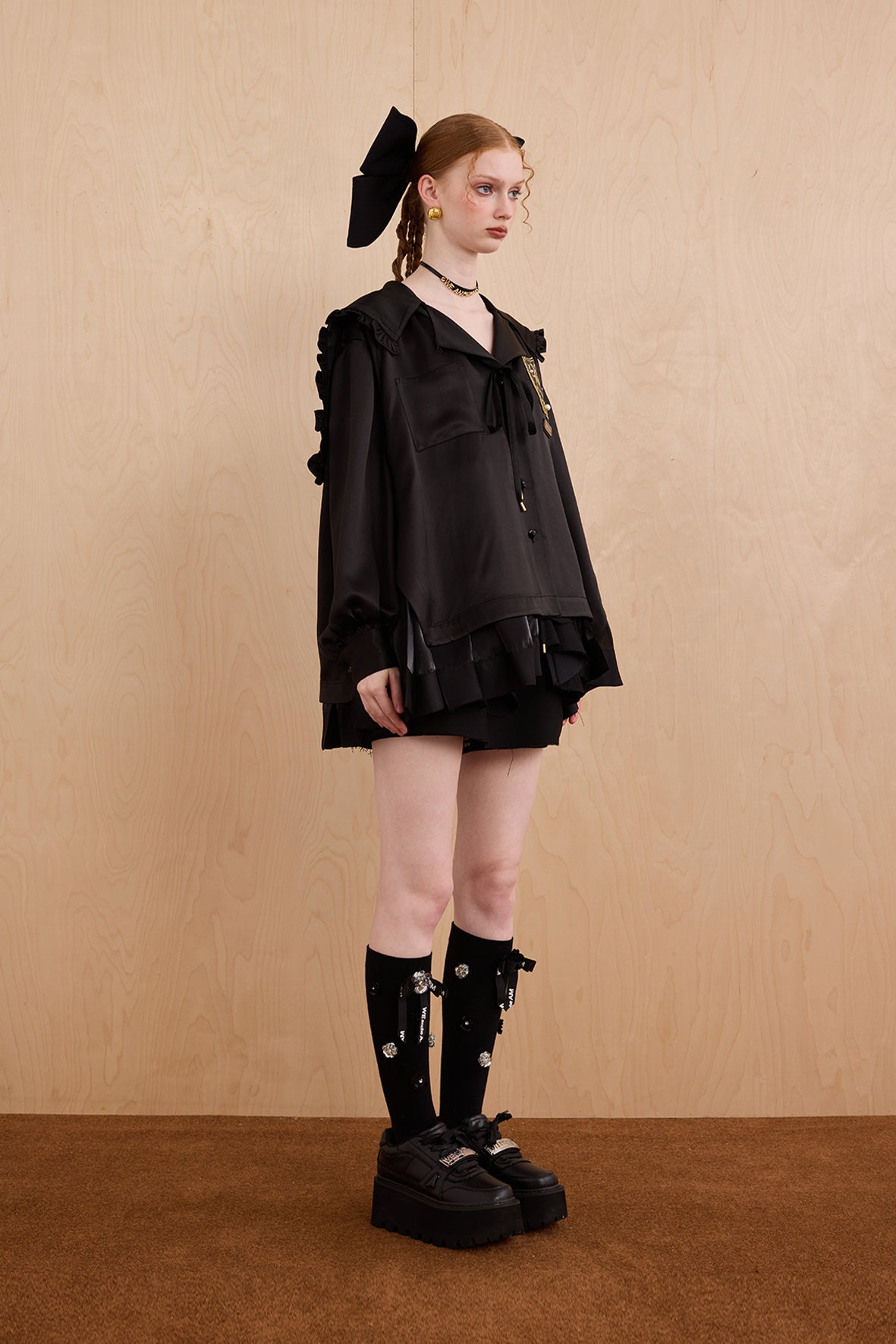 Model wearing sweet V-neck navy collar shirt dress with layered ruffle hem