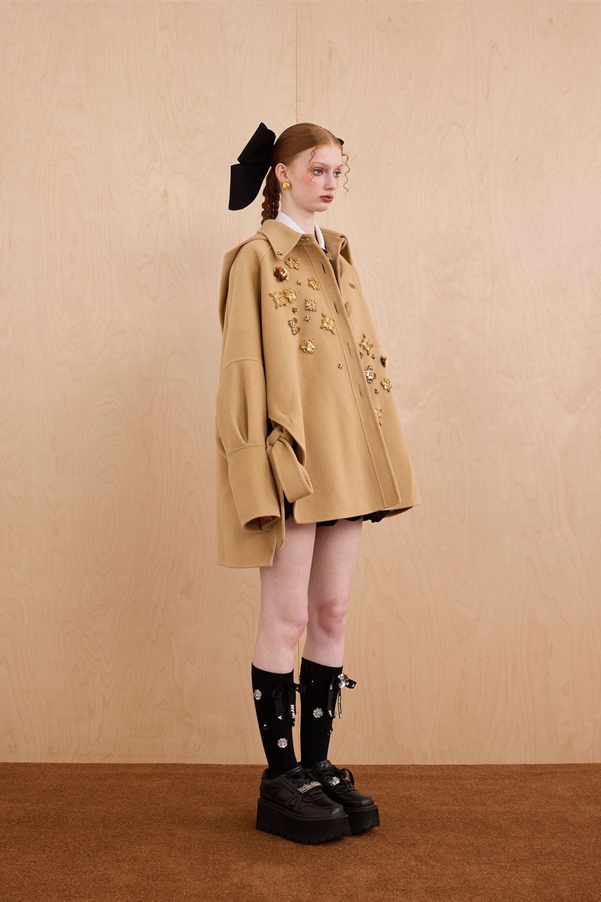 Model wearing merino wool reversible hoodie jacket with cat ears and bows