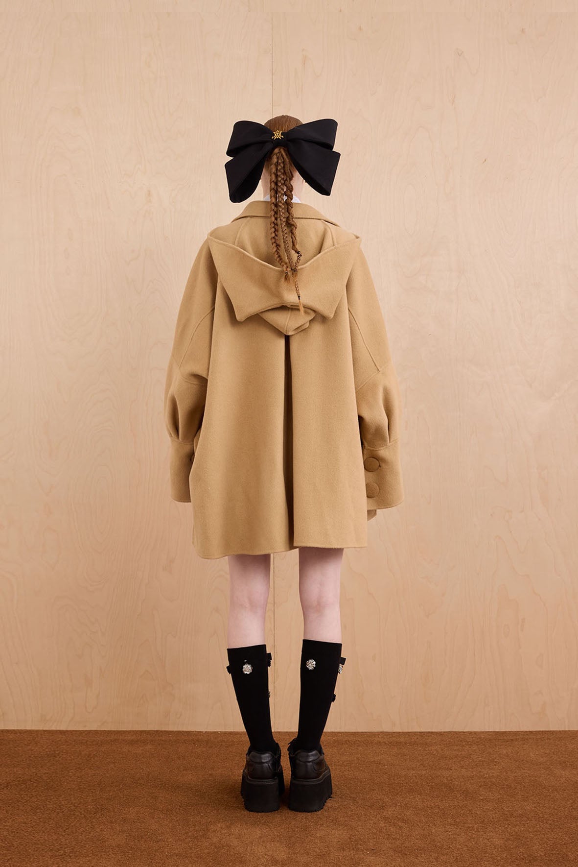 Model wearing merino wool reversible hoodie jacket with cat ears and bows