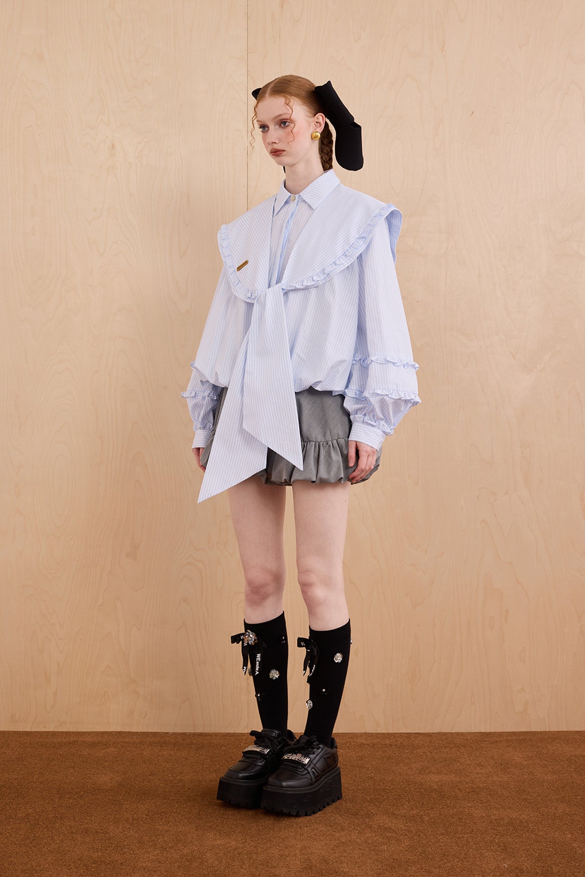 Model wearing college-style shirt with detachable navy collar and bubble hem