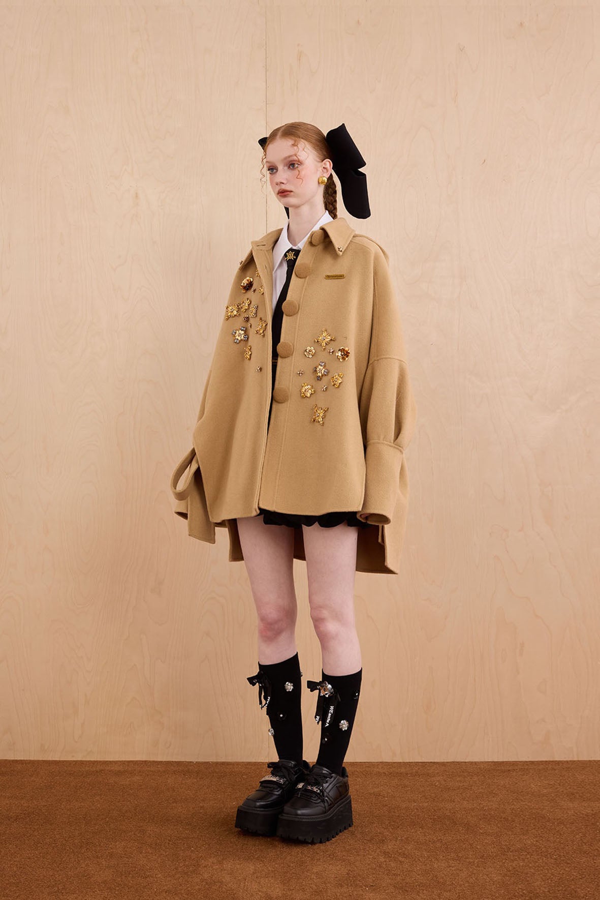 Model wearing merino wool reversible hoodie jacket with cat ears and bows