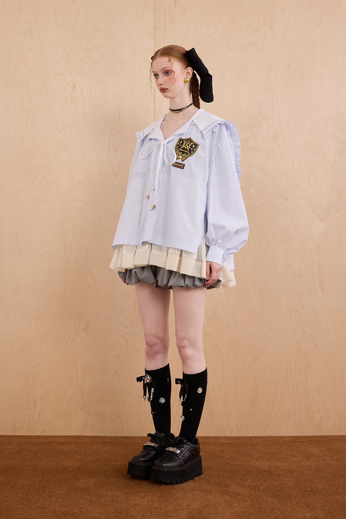 Model wearing sweet V-neck navy collar shirt dress with layered ruffle hem