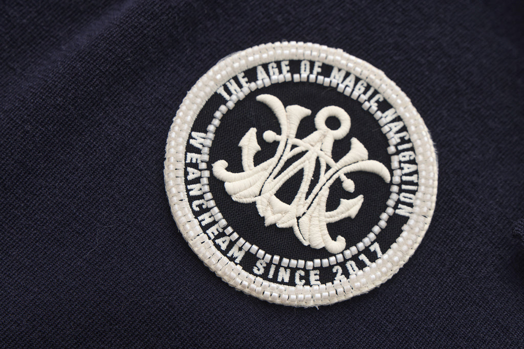 Close-up of navy collar and ribbon tie detail on retro knitted jacket