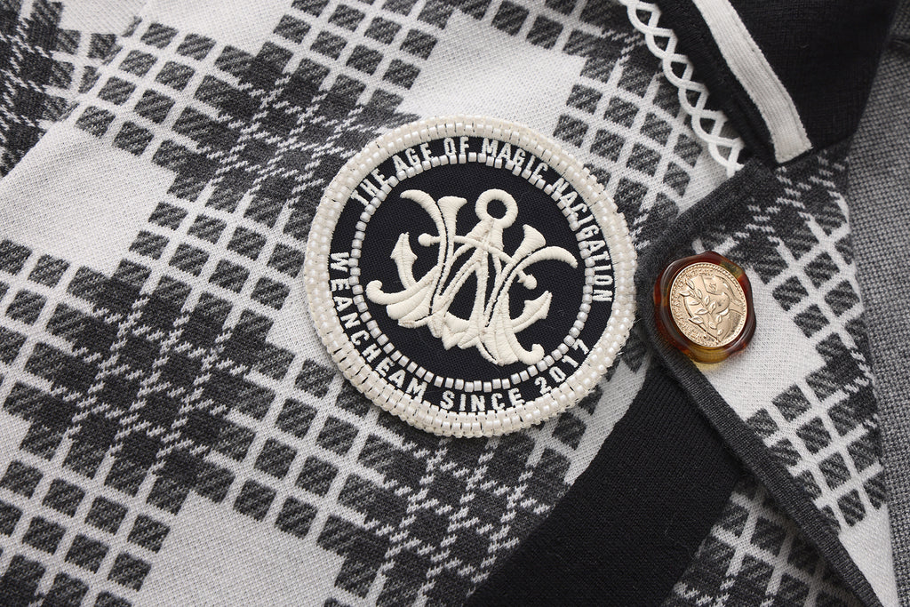 Close-up of navy collar and ribbon tie detail on retro knitted jacket