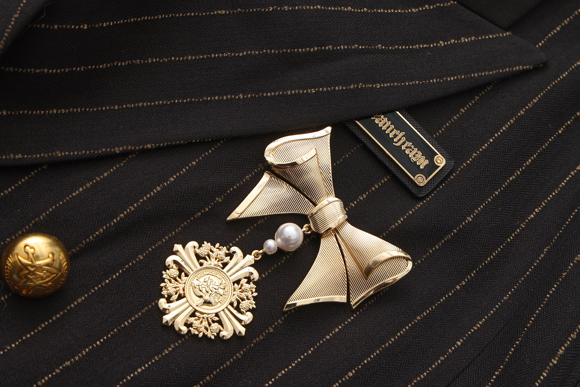 Close-up of wave-shaped hem and hand-painted fabric detail on artistic blazer