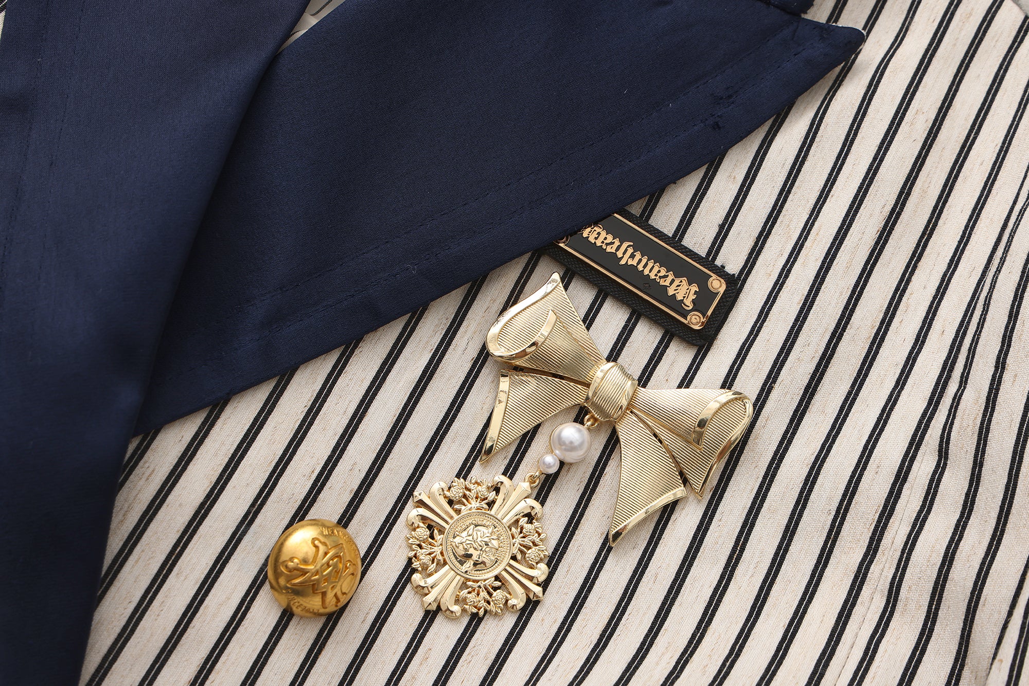 Close-up of wave-shaped hem and hand-painted fabric detail on artistic blazer