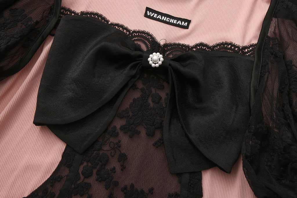 Close-up of lace fabric, detachable sleeve detail, and bow accent on vintage-style top