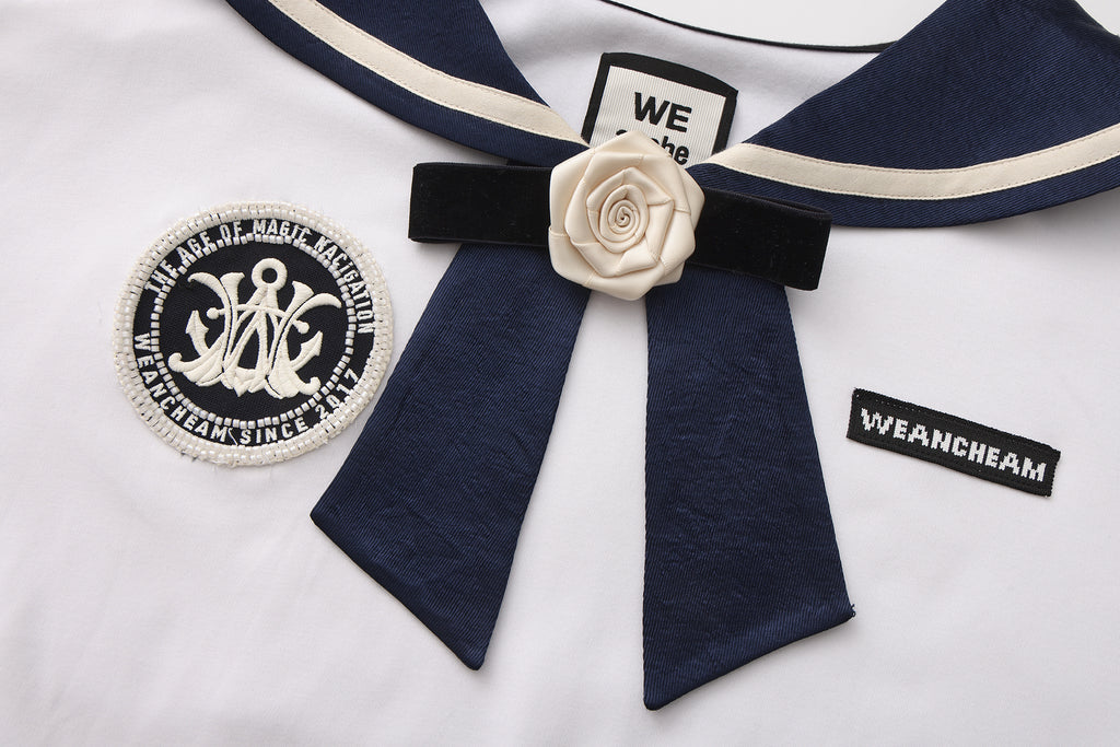 Close-up of satin navy collar and silk flower detail on cotton-modal T-shirt