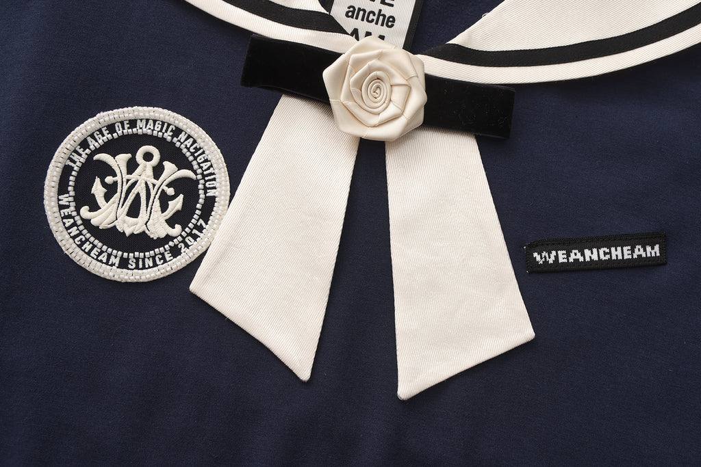 Close-up of satin navy collar and silk flower detail on cotton-modal T-shirt
