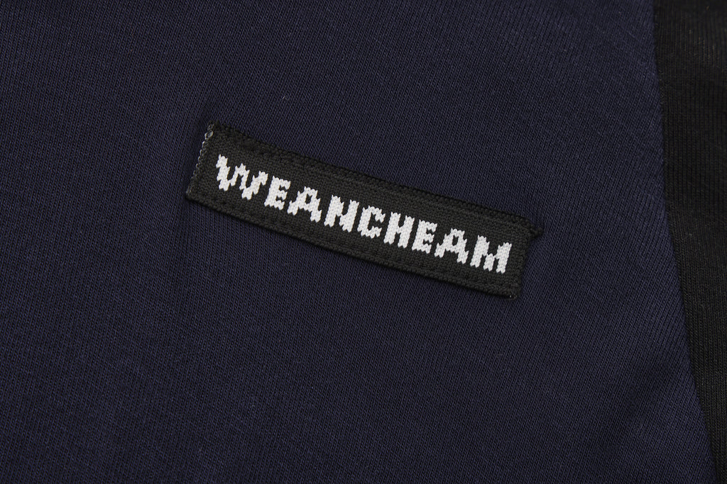 Close-up of beaded floral accent and layered faux two-piece detail on T-shirt