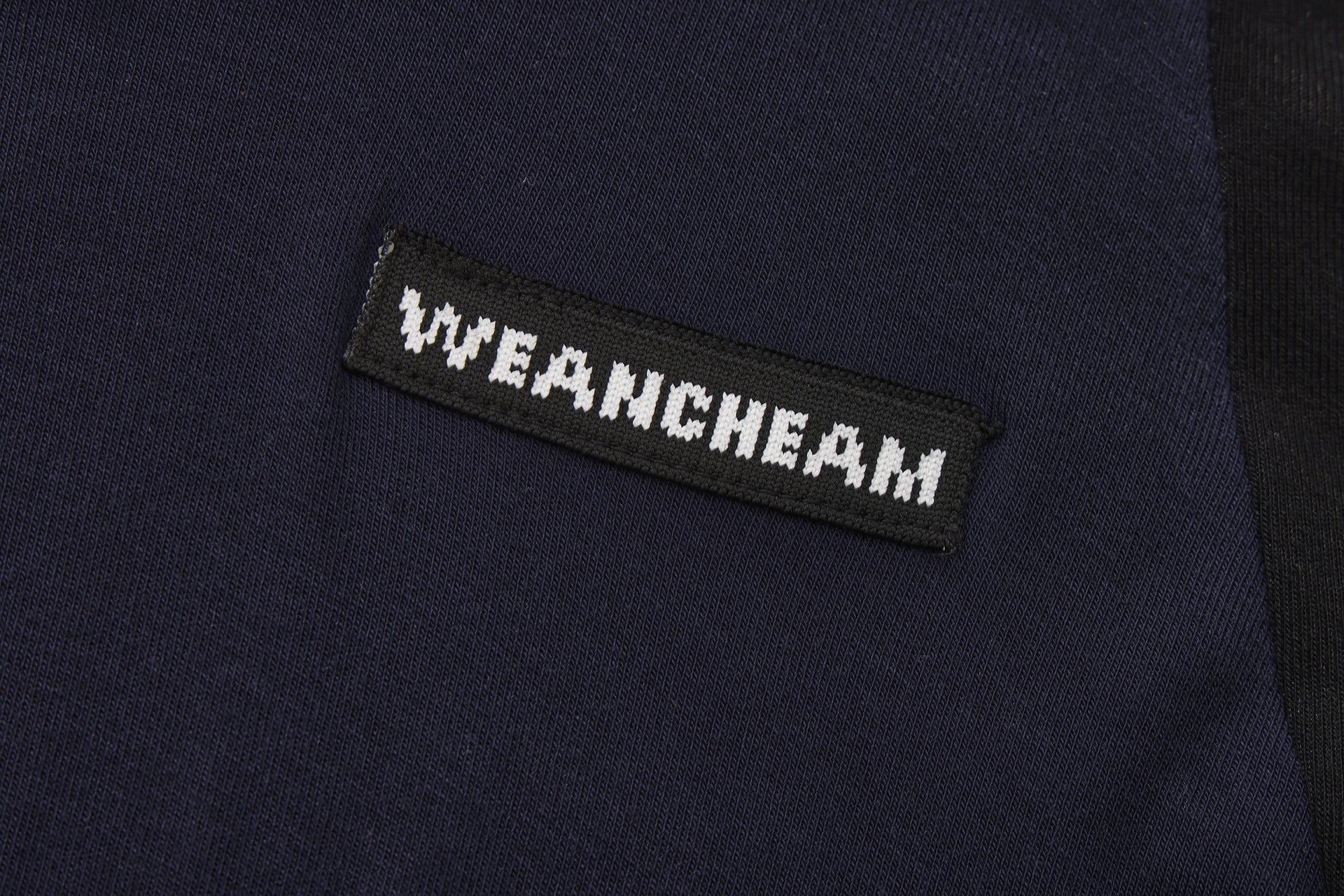 Close-up of beaded floral accent and layered faux two-piece detail on T-shirt