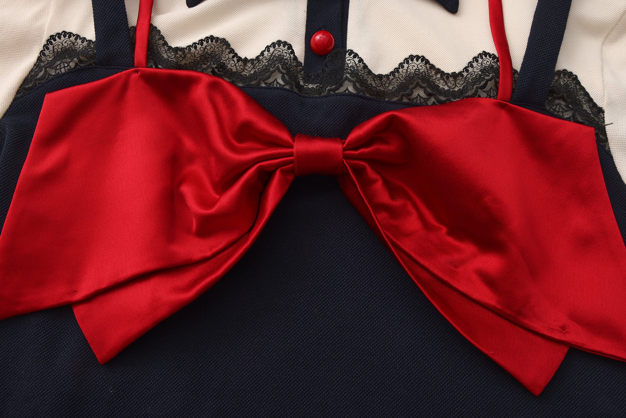 Close-up of bow-tie bandeau and halter layered detail on cotton slim-fit polo shirt