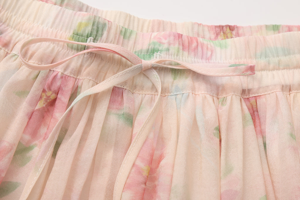 Close-up of lace hem, fishbone silhouette, and beaded waist detail on skirt