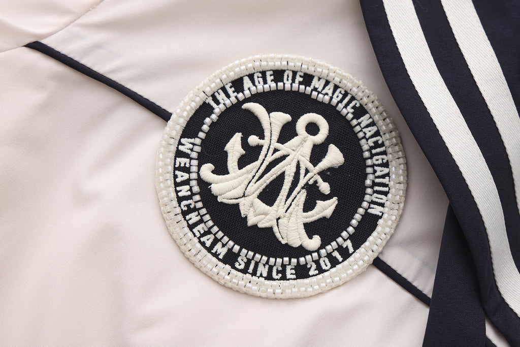 Close-up of striped accents and nylon wrinkle-resistant fabric on navy collar dress