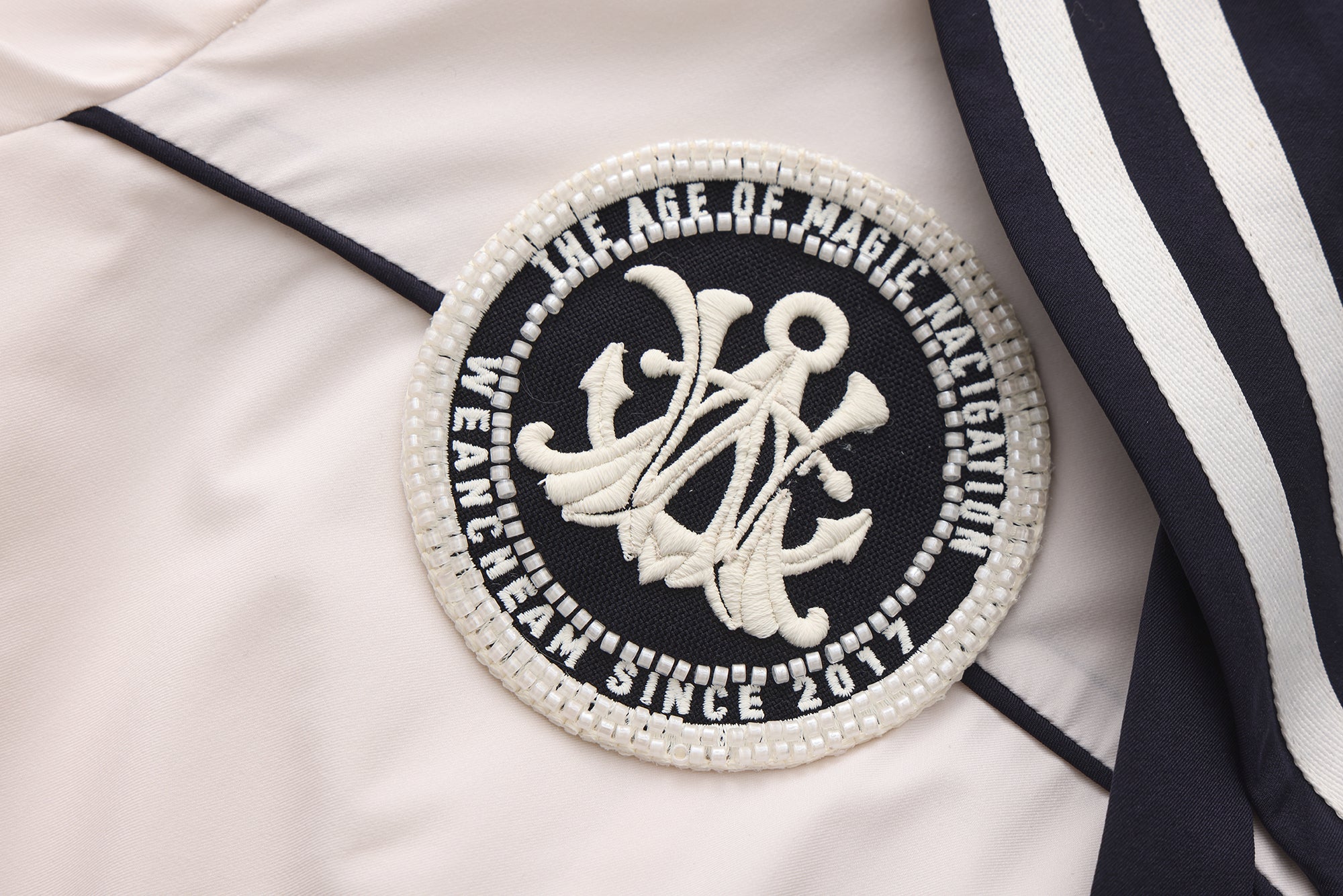 Close-up of striped accents and nylon wrinkle-resistant fabric on navy collar dress