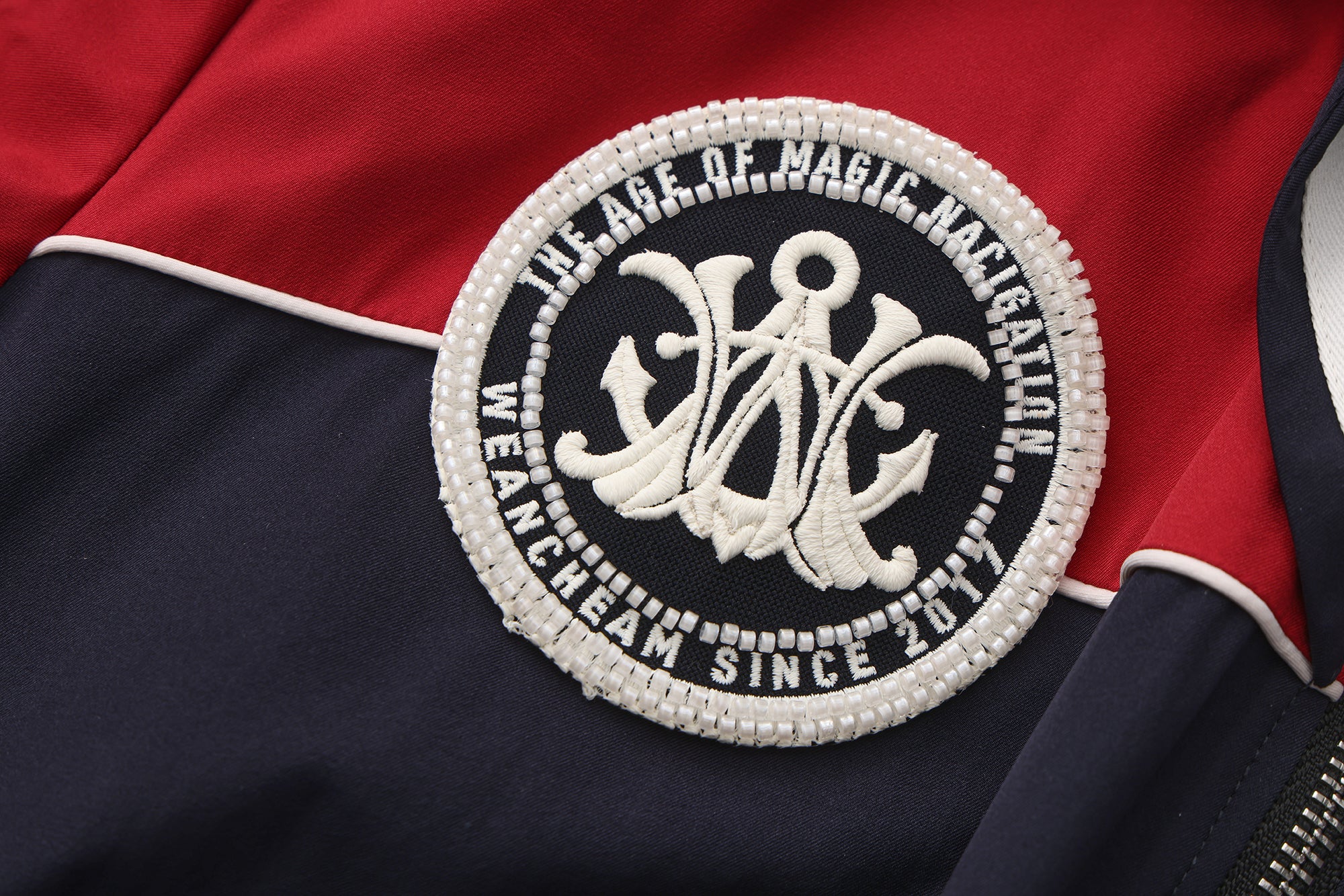 Close-up of striped accents and nylon wrinkle-resistant fabric on navy collar dress