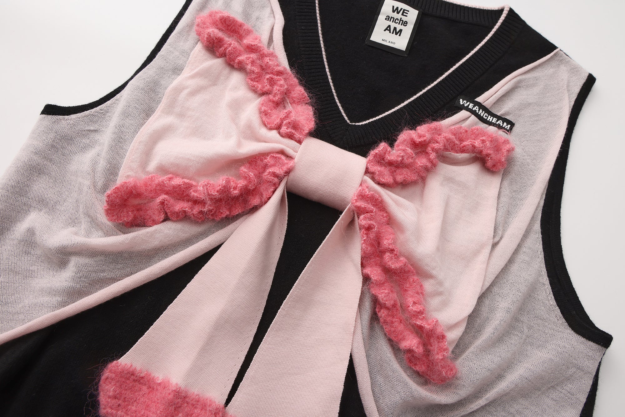 Close-up of crocheted edge and wool knit texture on bow tank top