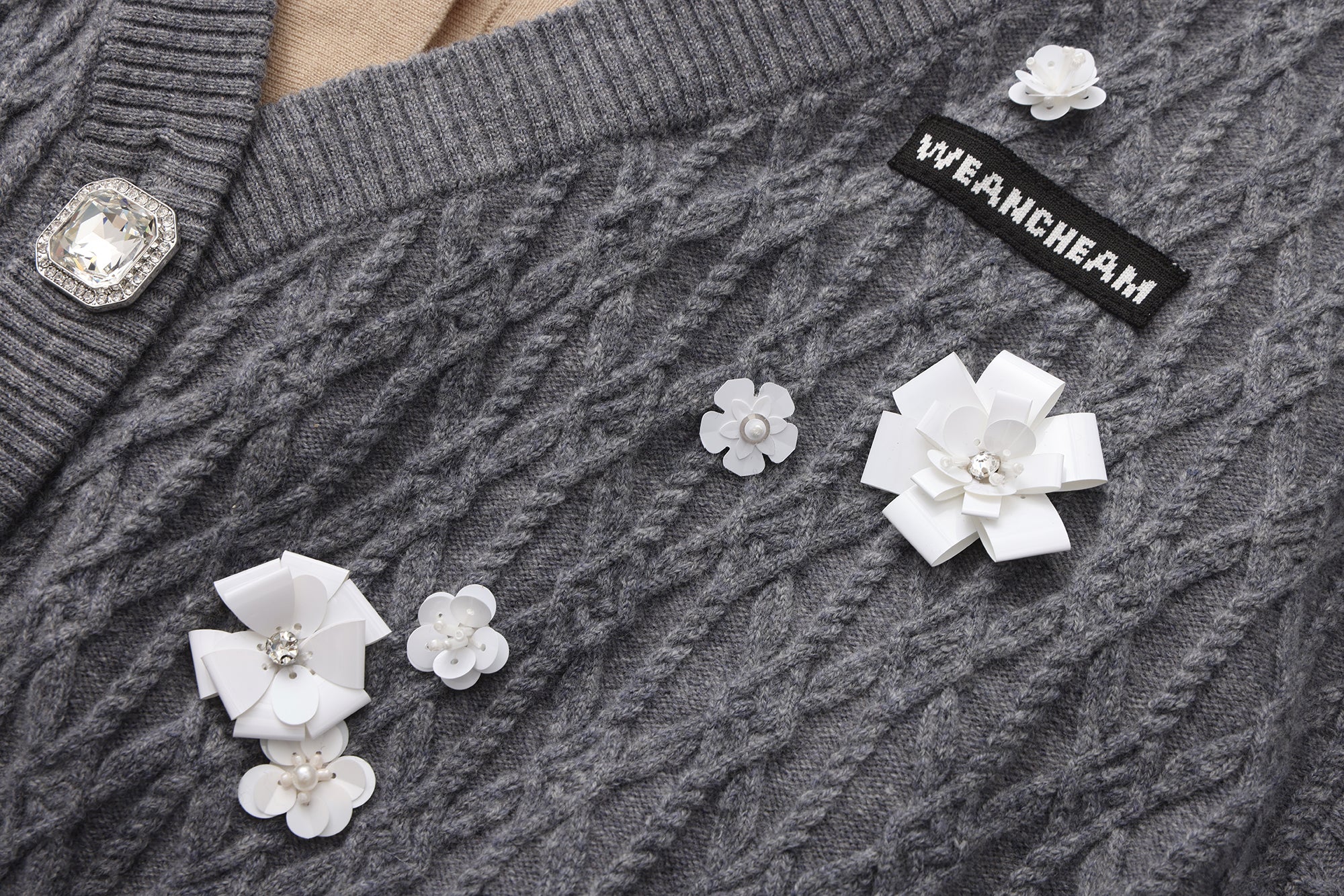 Close-up of bead embellishments and lace-trim collar on faux two-piece cardigan