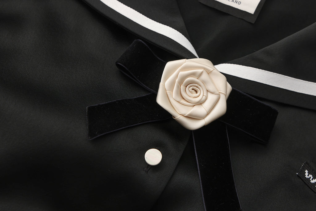 Close-up of lace trim and asymmetric hem on navy collar shirt