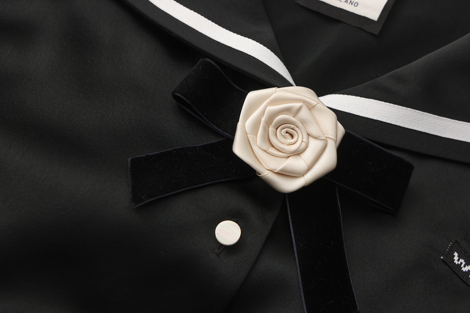 Close-up of lace trim and asymmetric hem on navy collar shirt