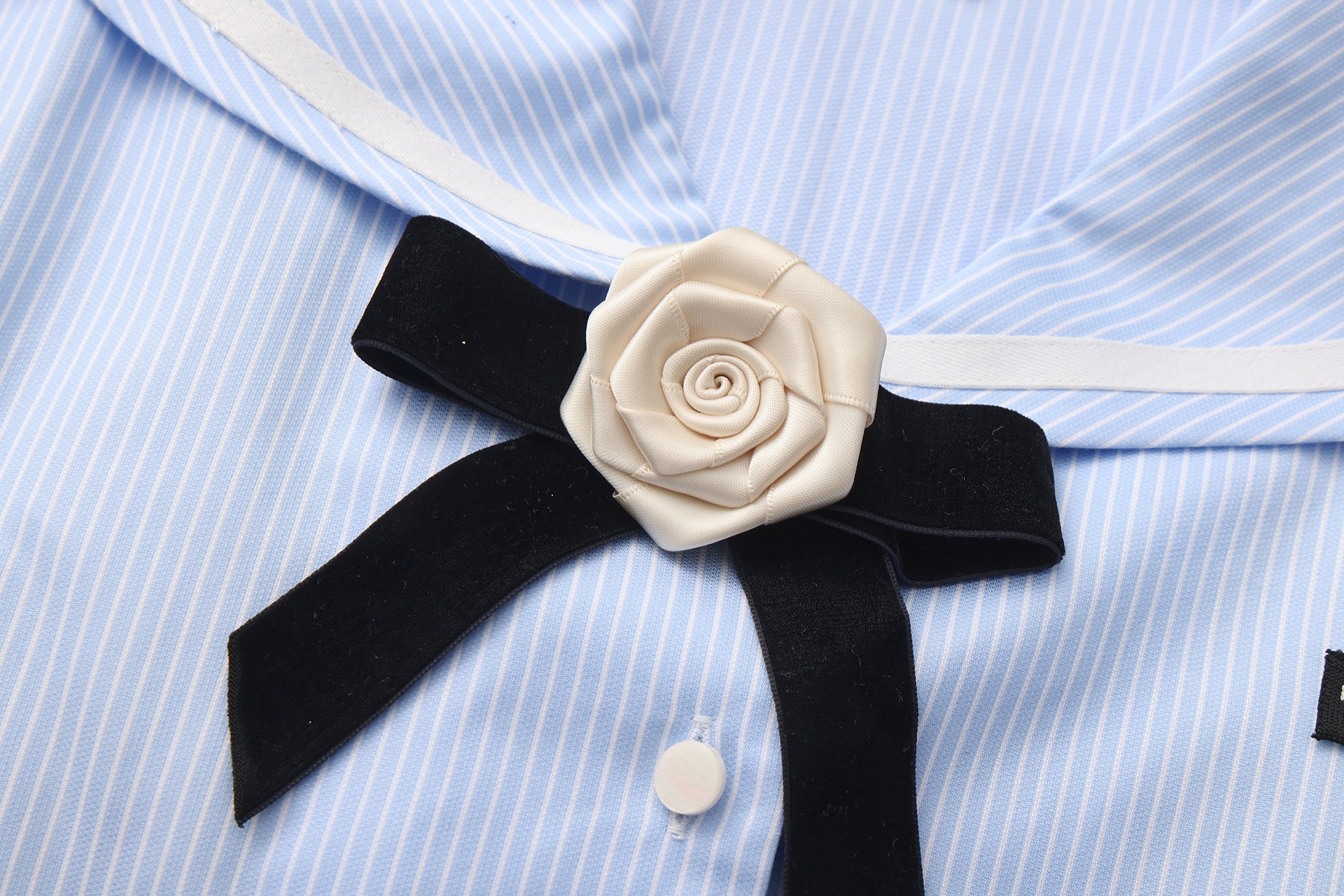 Close-up of lace trim and asymmetric hem on navy collar shirt