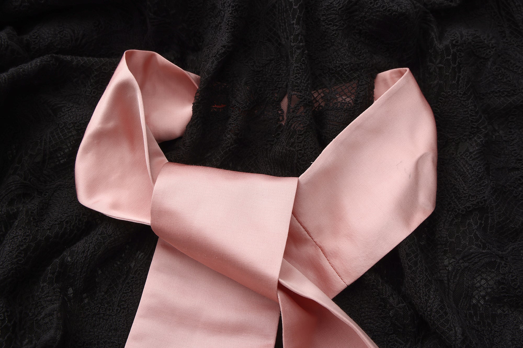 Close-up of bow tie neckline and 3D floral lace details on tulle dress