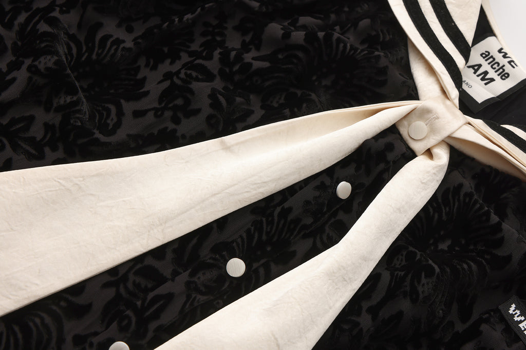 Close-up of ribbon neckline and smooth breathable fabric on navy collar dress