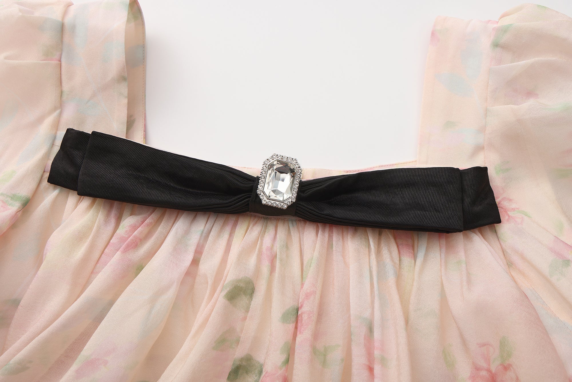Close-up of ruffled layers and silky fabric texture on bubble sleeve dress