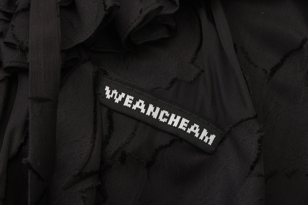 Close-up of fishbone detailing and lace-trim mesh fabric on floral dress