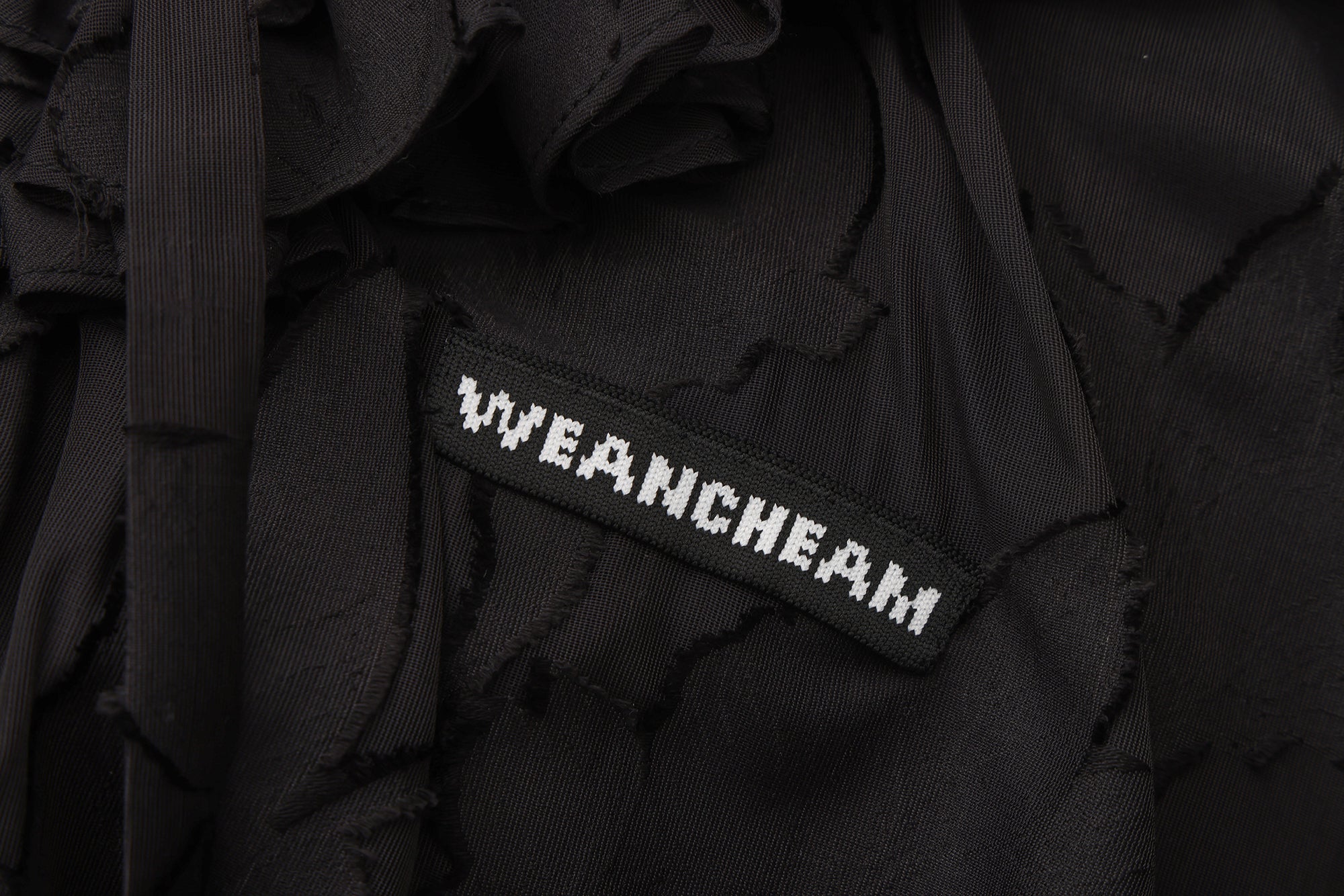 Close-up of fishbone detailing and lace-trim mesh fabric on floral dress