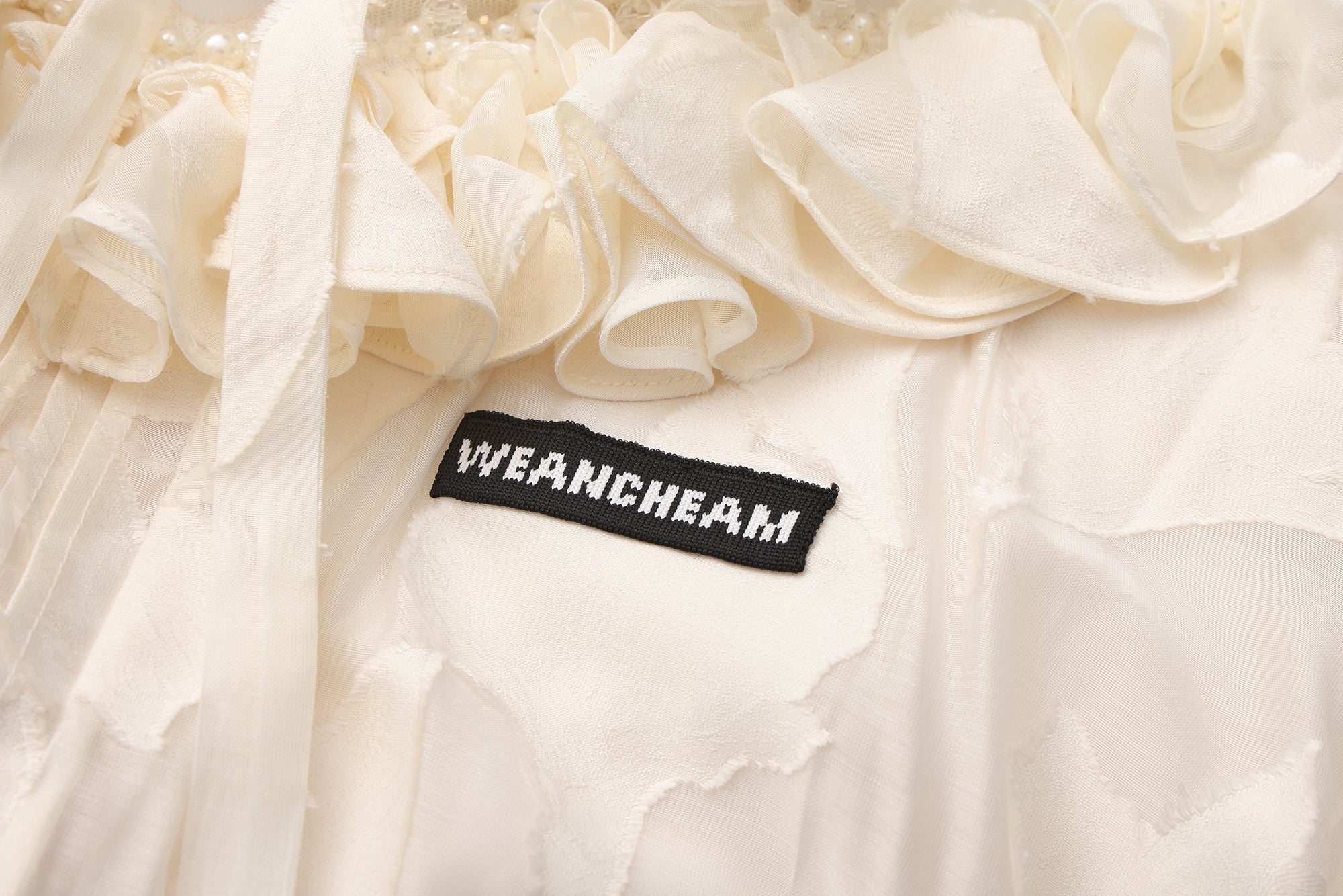 Close-up of fishbone detailing and lace-trim mesh fabric on floral dress
