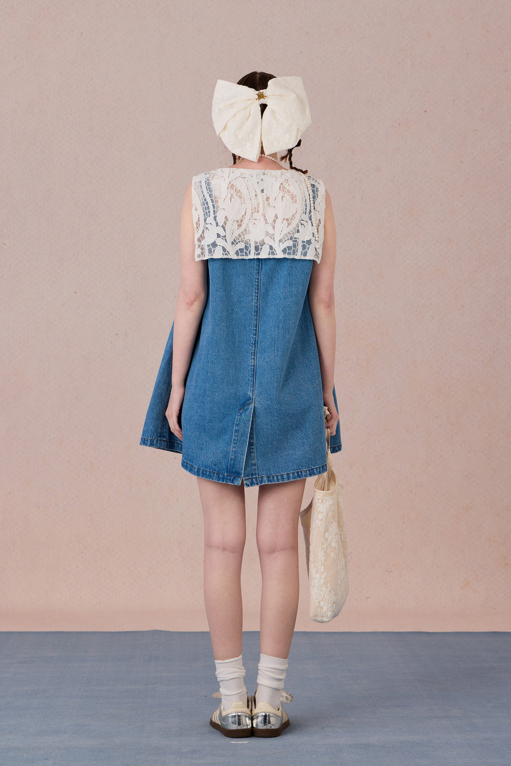 Relaxed fit back view of button-down lace trimmed denim dress