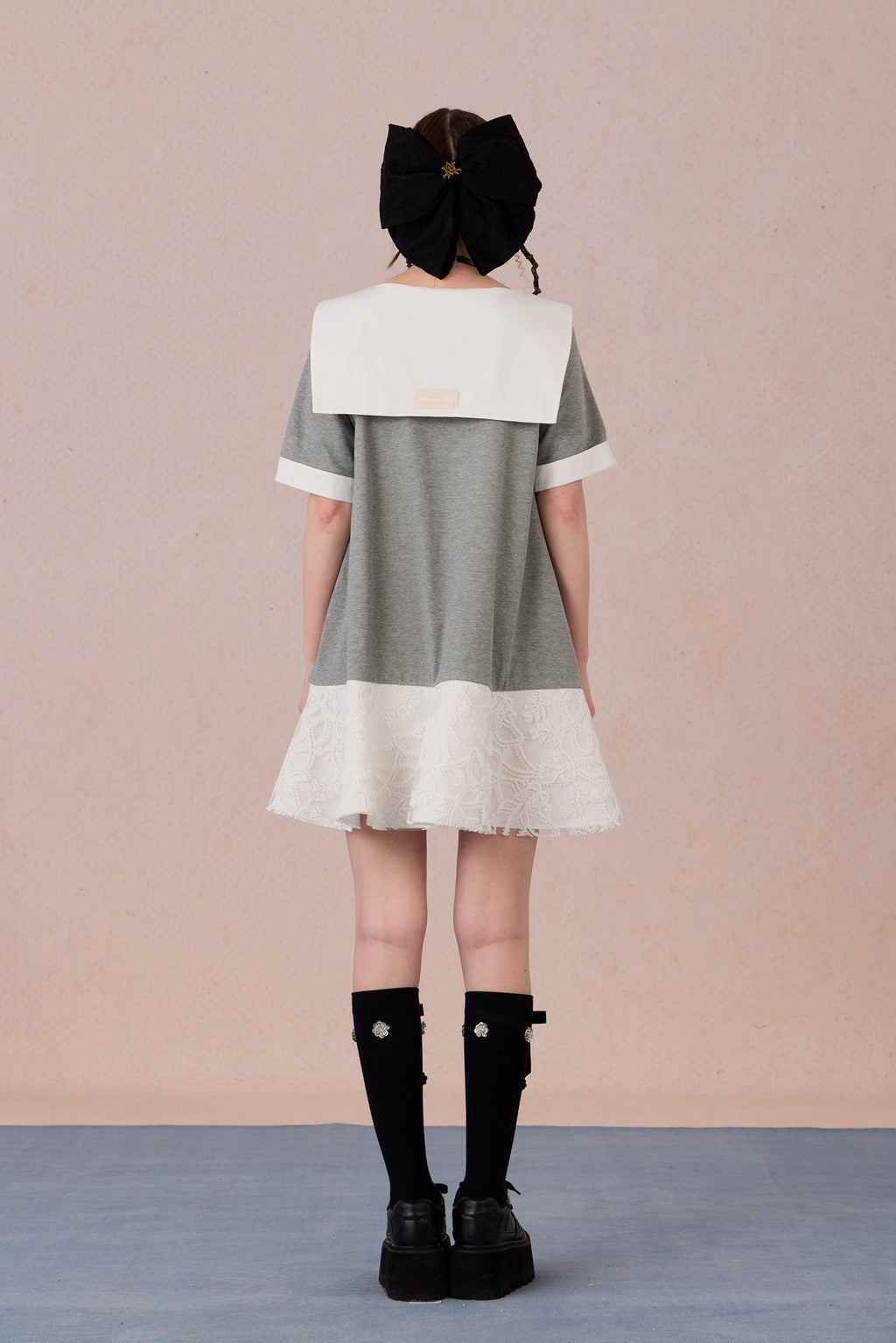 Relaxed fit floral cotton dress with navy border and romantic lace hemline