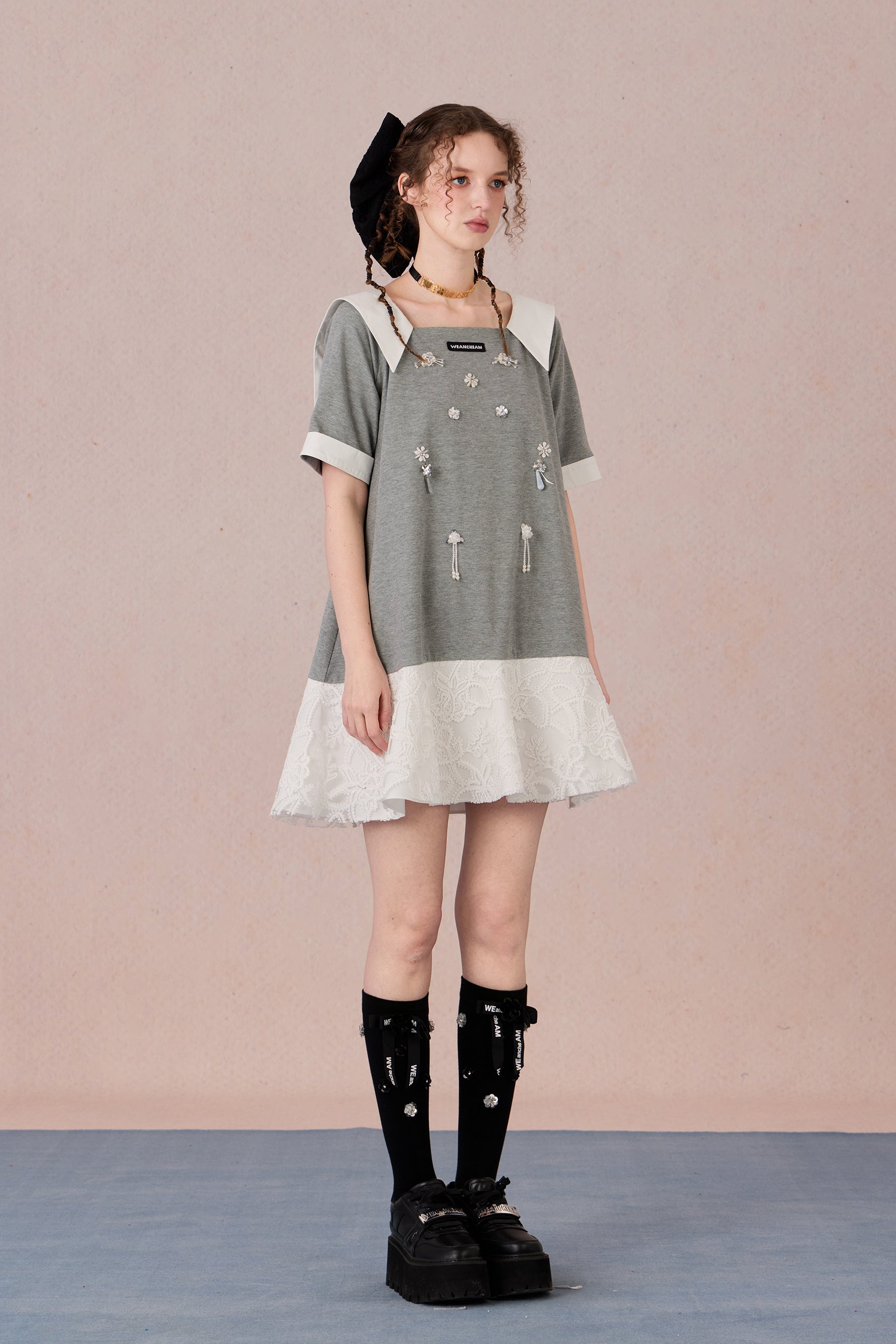 Relaxed fit floral cotton dress with navy border and romantic lace hemline