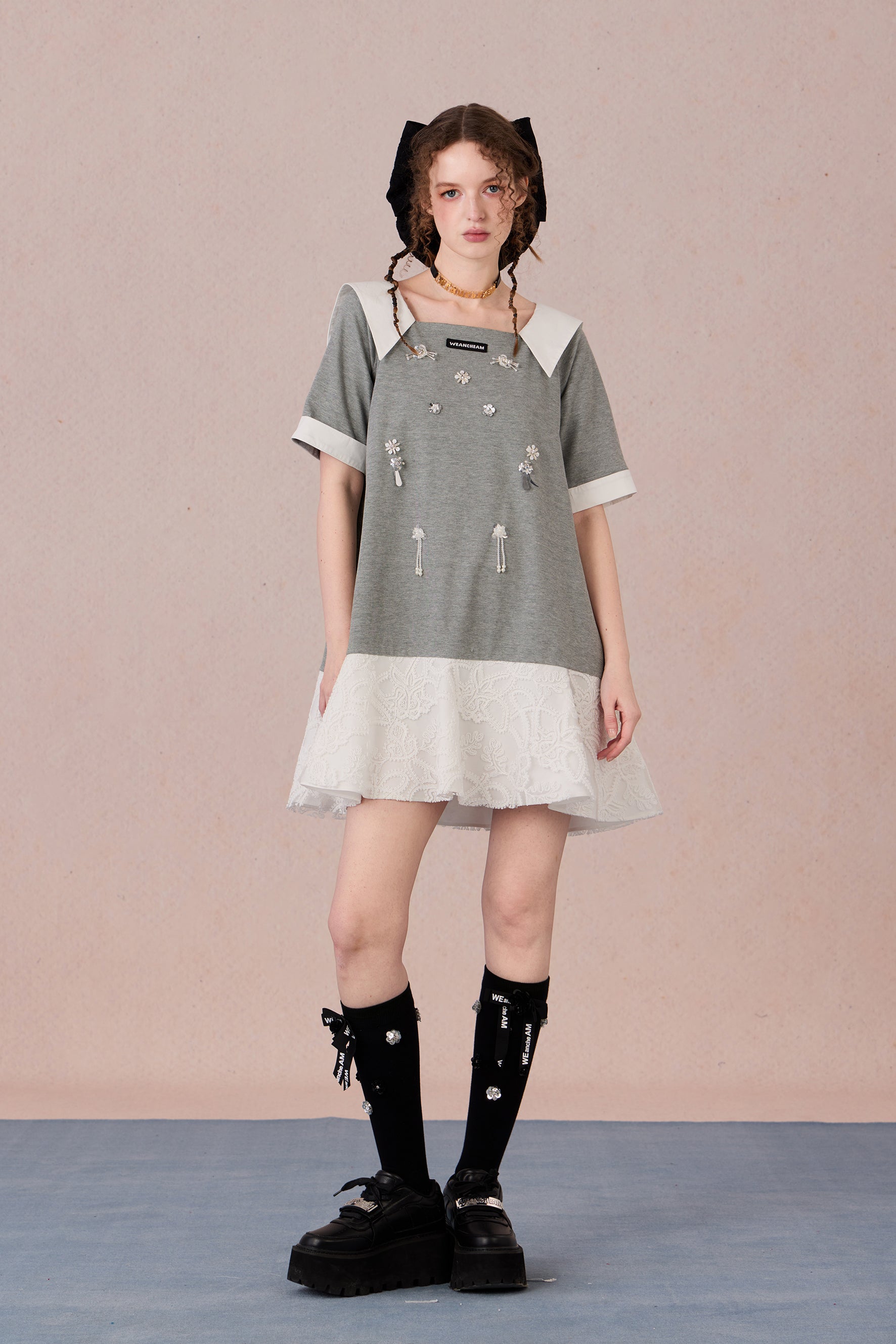 Relaxed fit floral cotton dress with navy border and romantic lace hemline
