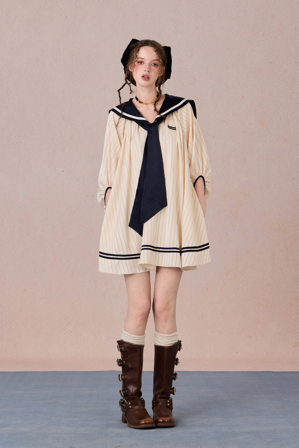Relaxed tie-neck flutter sleeve dress in navy and black trim