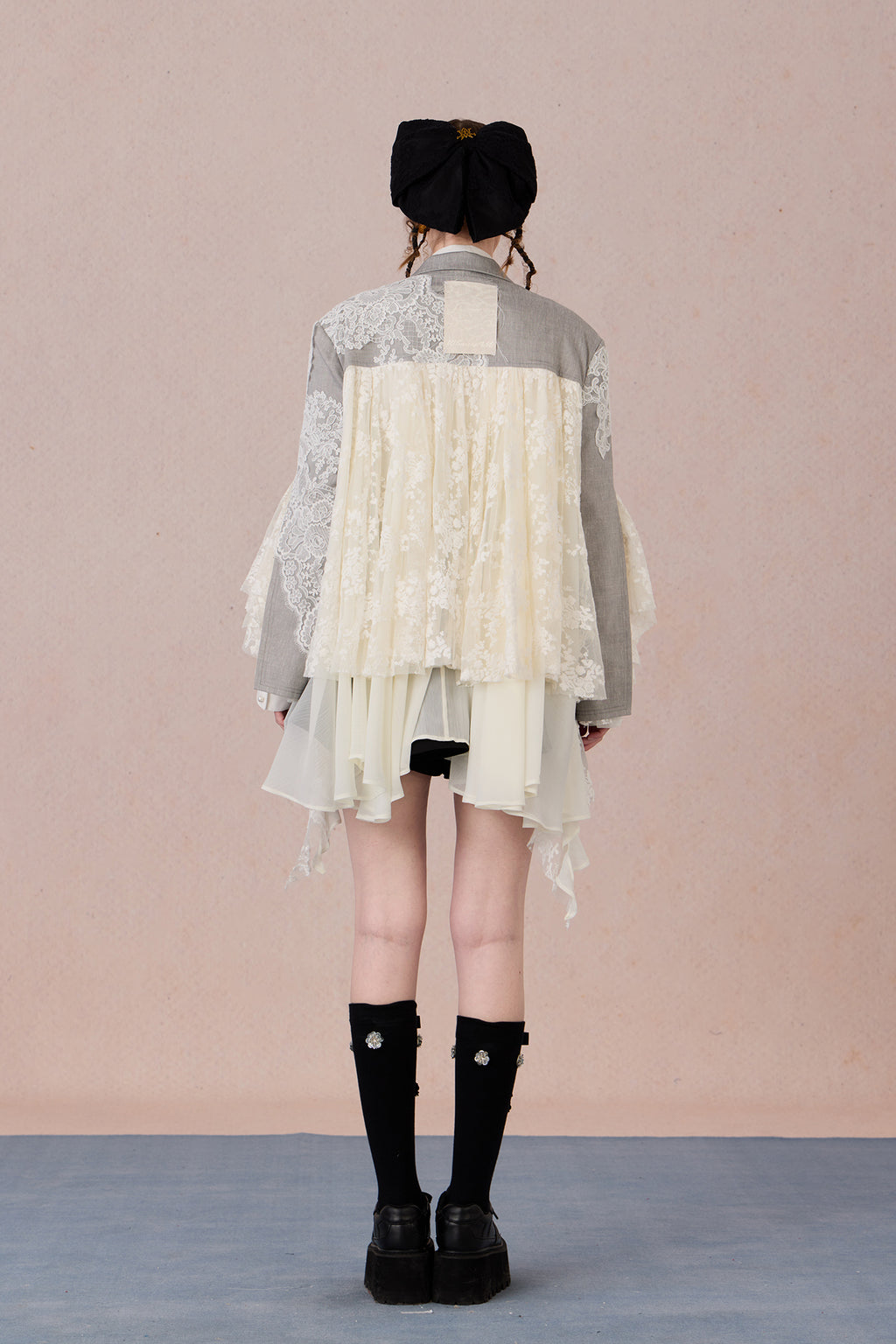 Lace collage back panel with draped asymmetry and sharp structure