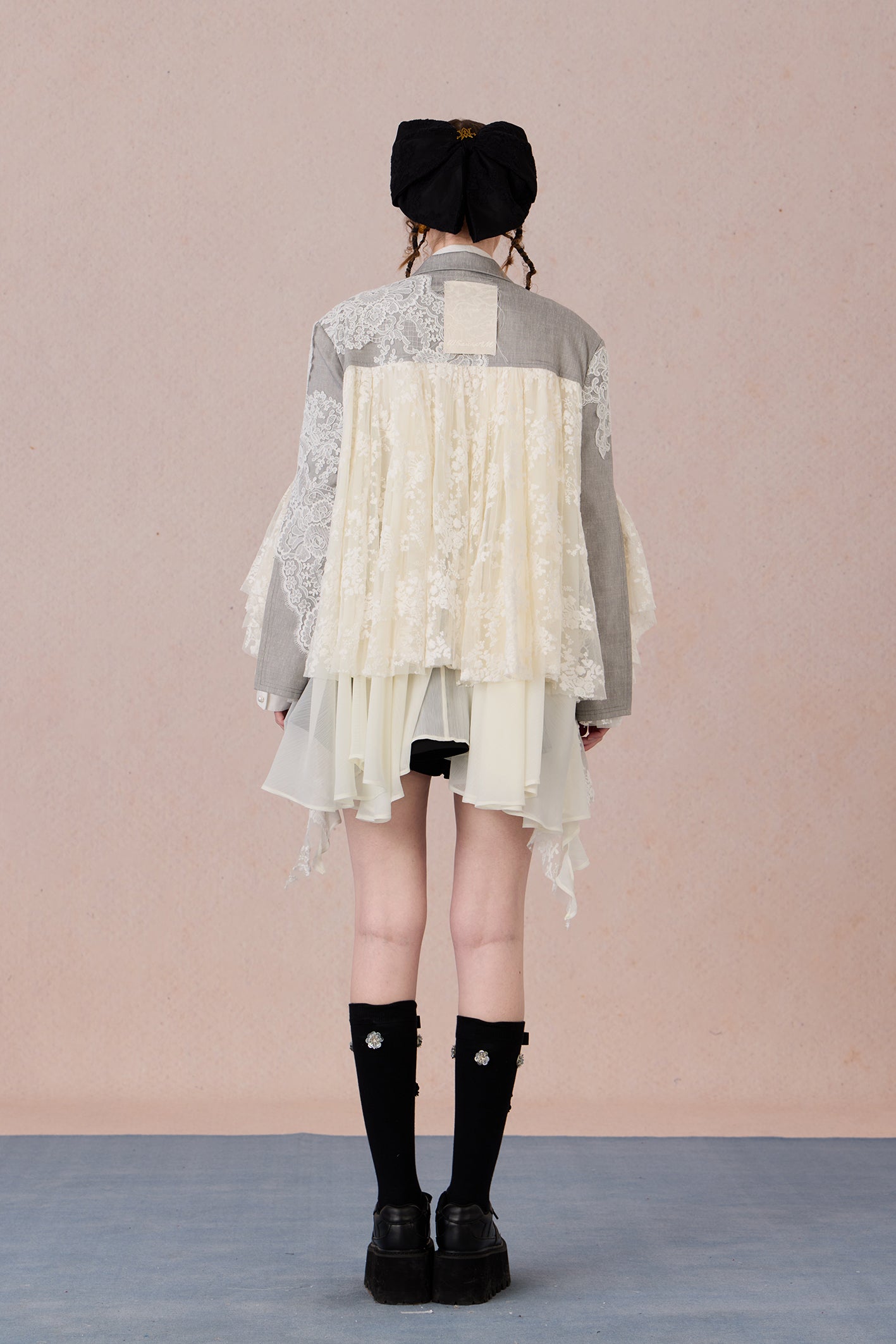 Lace collage back panel with draped asymmetry and sharp structure