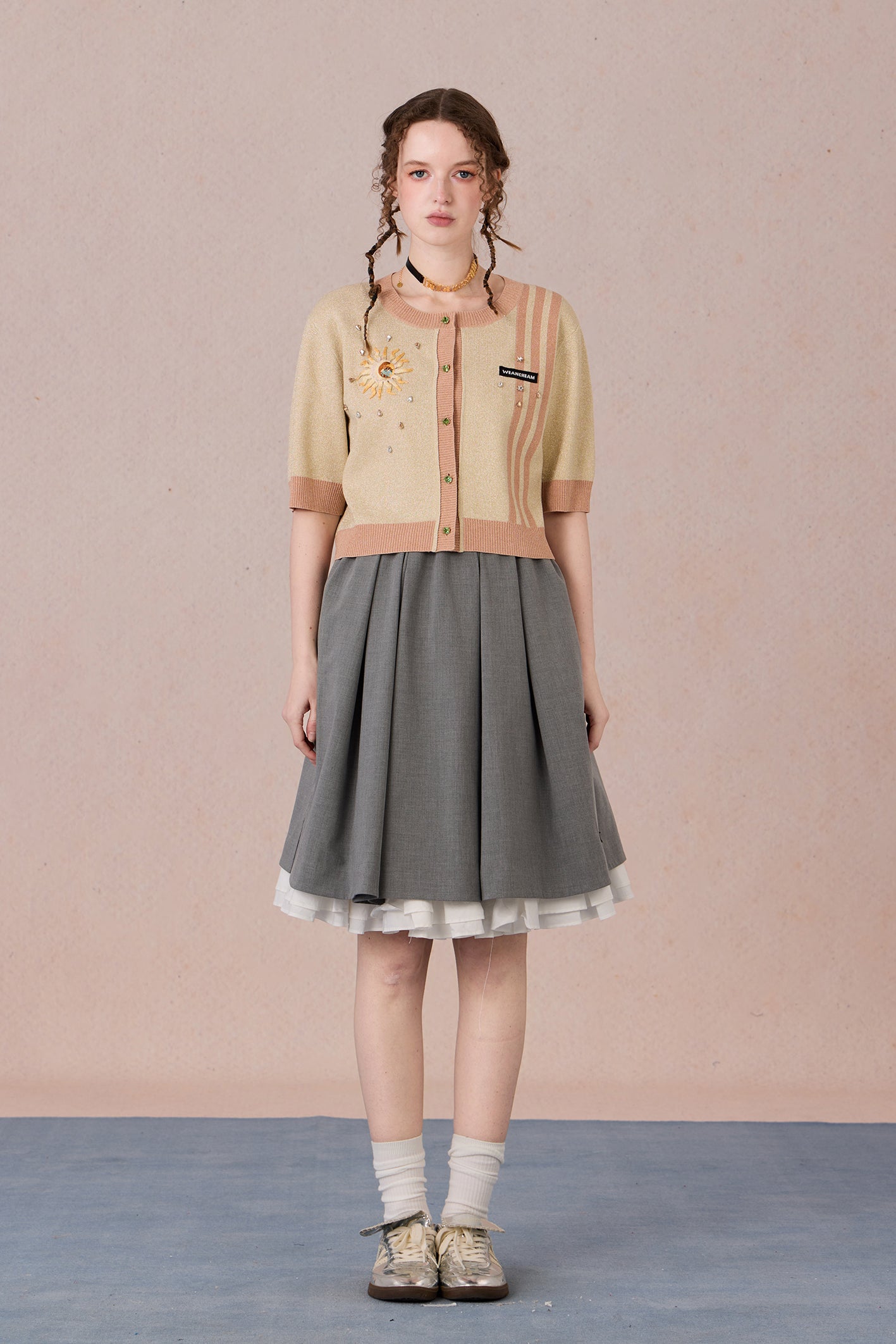 Model wearing beige slim-fit Helios cardigan with hand-painted chest detail – WEANCHEAM